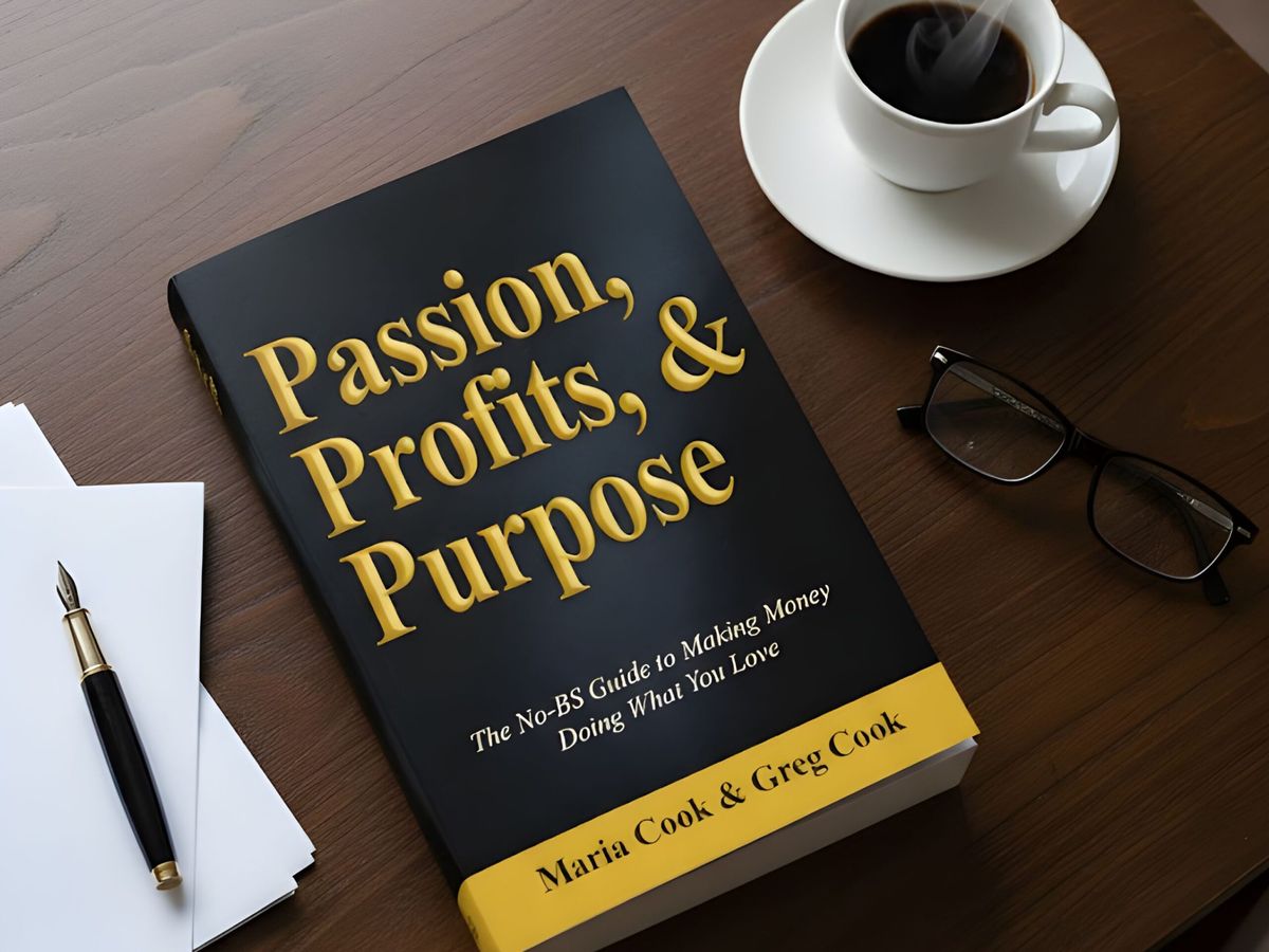 Passion, Profits, & Purpose by Maria Cook and Greg Cook, lying on a desk beside a cup of coffee